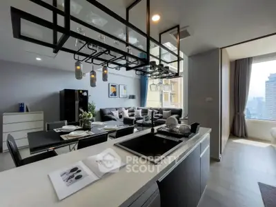 Modern open-layout kitchen and living room with city view, stylish lighting, and elegant decor.