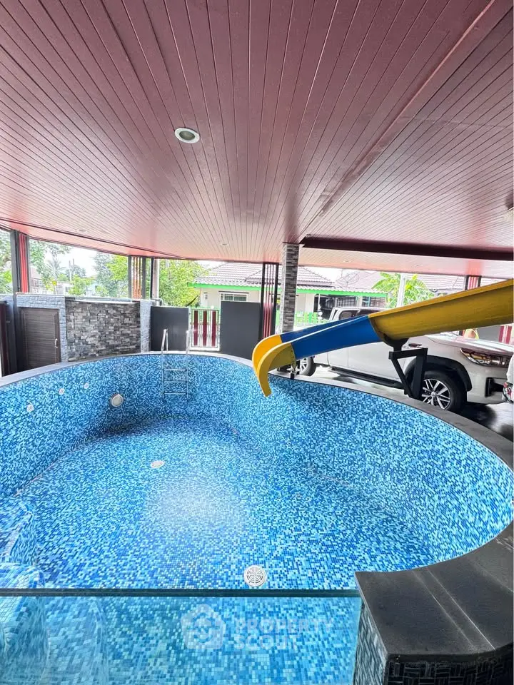 Unique indoor pool with slide and parking area, perfect for family entertainment.