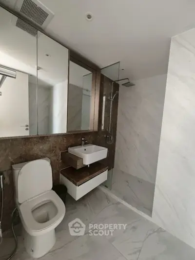 Modern bathroom with sleek fixtures and marble tiles