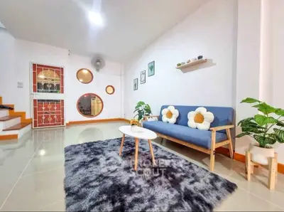 Charming living room with modern decor and cozy seating area.