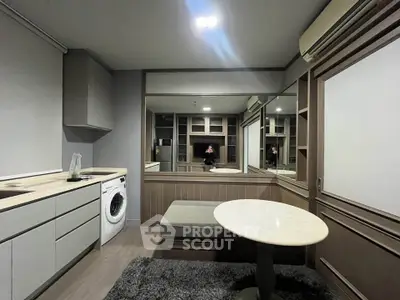 Modern compact living room with built-in storage and washing machine