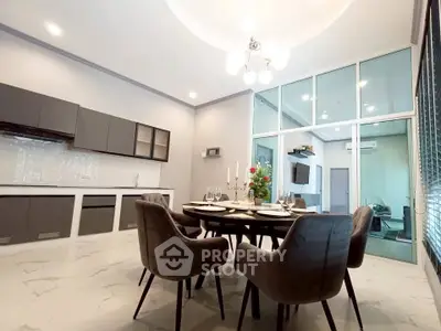 Modern dining area with elegant chandelier and open kitchen layout