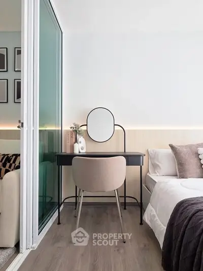 Modern bedroom with stylish vanity and cozy decor in a chic apartment.