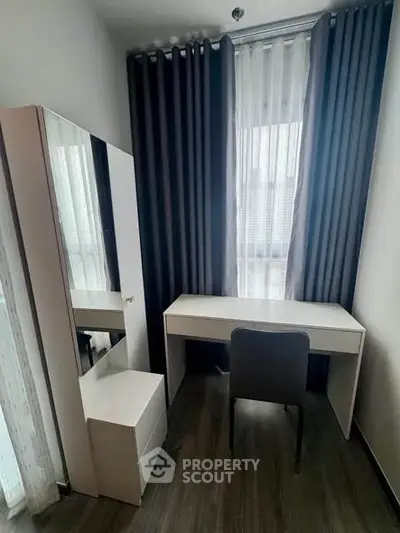 Modern study room with sleek desk and chair, featuring floor-to-ceiling window and elegant curtains.