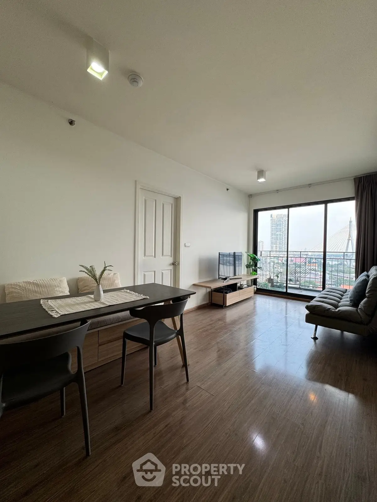 Spacious living room with city view and modern furnishings