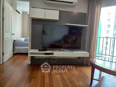 Modern living room with sleek TV setup and balcony view