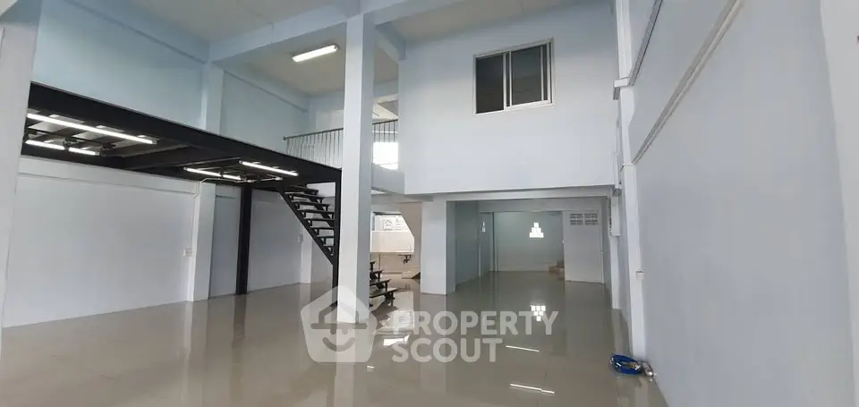 Spacious industrial-style loft with high ceilings and mezzanine level, perfect for creative workspace or modern living.