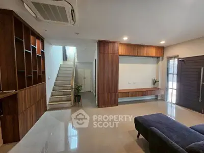 Spacious modern living room with sleek wooden accents and natural light