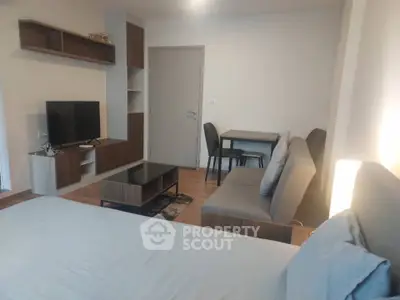 Modern studio apartment with cozy living area and stylish furniture
