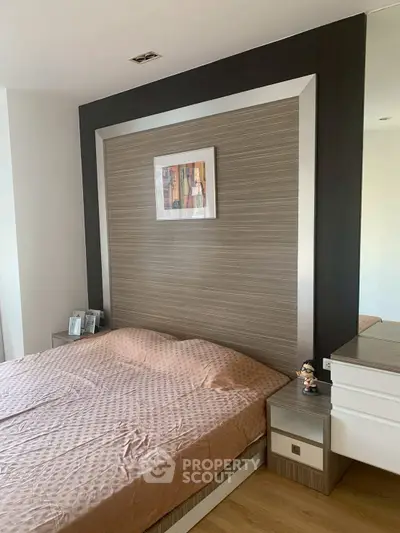 Modern bedroom with stylish headboard and cozy bedding in a contemporary apartment.
