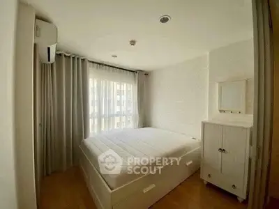 Cozy bedroom with natural light, featuring a comfortable bed and stylish decor.