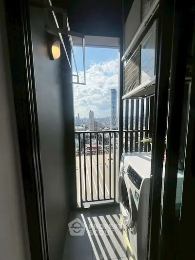 Modern balcony with laundry area and city skyline view