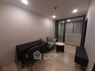 Modern living room with sleek furniture and balcony access