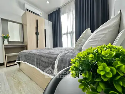 Modern bedroom with stylish decor and natural light, featuring a cozy bed and elegant furnishings.