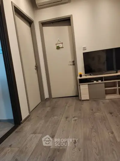 Modern living room with sleek flooring and stylish TV setup
