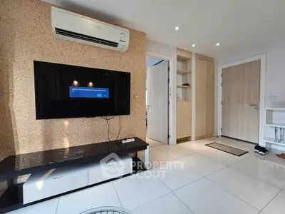 Modern living room with sleek TV setup and stylish air conditioning unit.