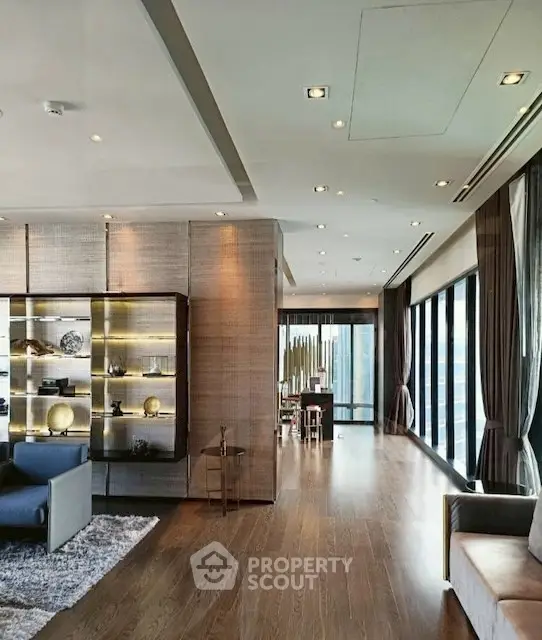 Luxurious open-plan living room with floor-to-ceiling windows and elegant decor
