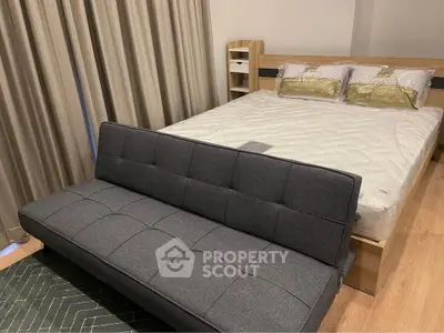 Modern bedroom with stylish bed and cozy sofa, perfect for relaxation and comfort.