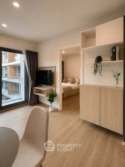 Modern apartment interior with open living room and bedroom view
