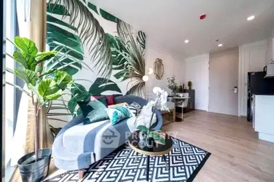 Stylish living room with tropical wallpaper and modern decor in a bright apartment.