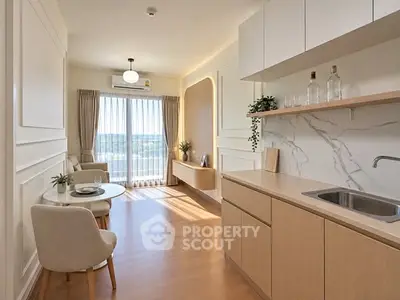 Modern living room with open kitchen, natural light, and elegant decor.