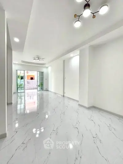 Spacious modern living room with marble flooring and stylish lighting