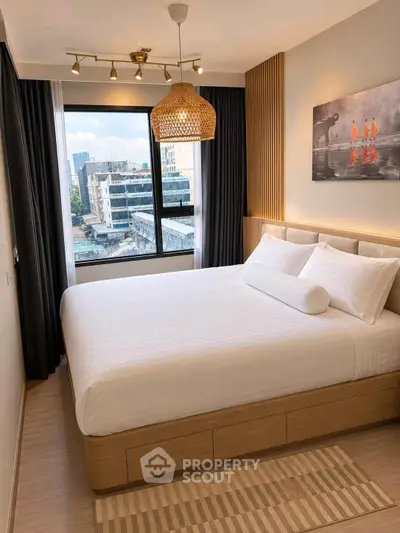 Modern bedroom with large window and stylish decor in urban apartment