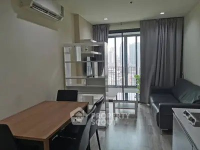 Modern living room with city view, featuring sleek furniture and large windows for natural light.