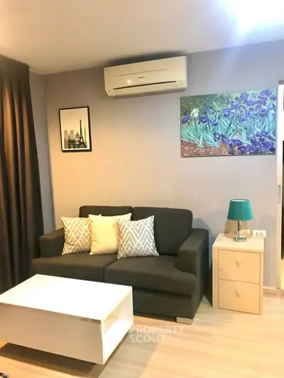 Cozy living room with modern decor, featuring a comfortable sofa, stylish artwork, and ambient lighting.