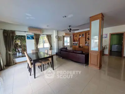 Spacious living room with dining area and large windows for natural light.