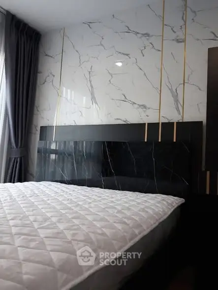 Luxurious bedroom with elegant marble accent wall and plush bedding