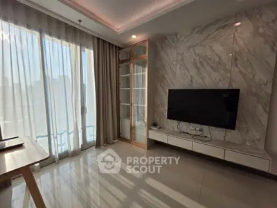 Modern living room with marble accent wall and large window offering natural light.