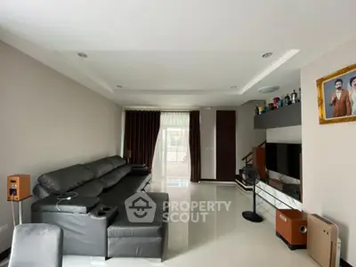 Spacious modern living room with sleek leather sofa and entertainment center