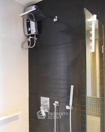 Modern bathroom with sleek shower fixtures and glass partition