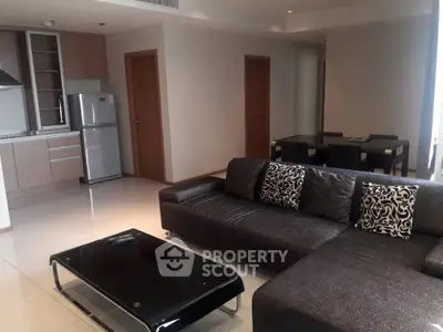 Modern open-plan living room with sleek kitchen and stylish furniture in a contemporary apartment.