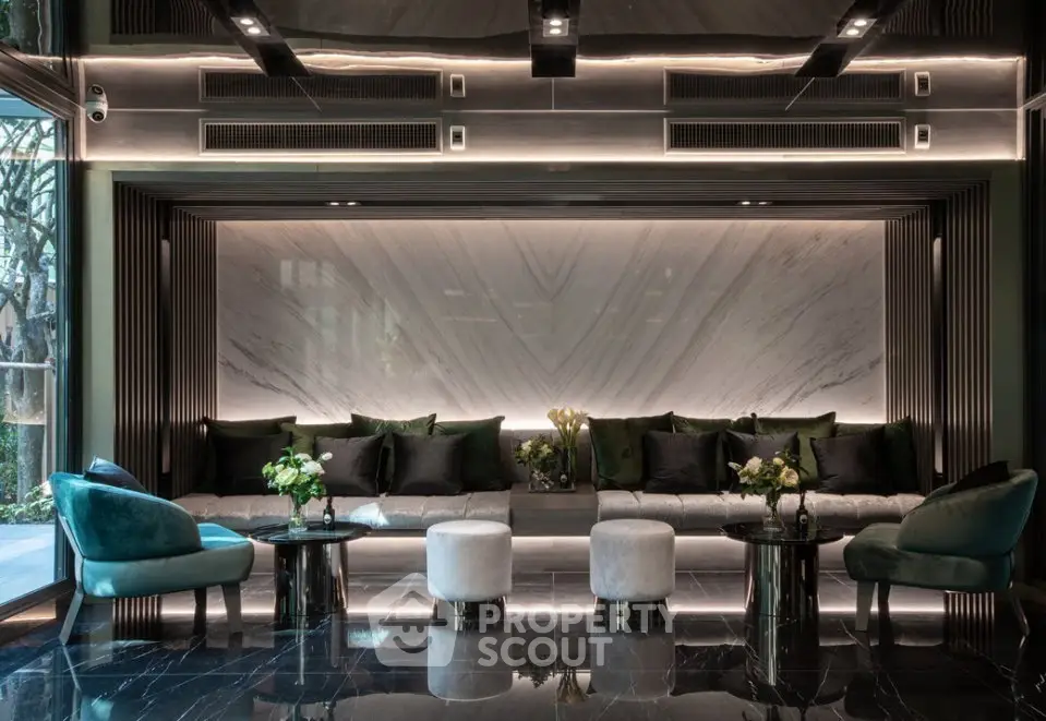 Luxurious modern lobby with elegant seating and marble accents in upscale building.