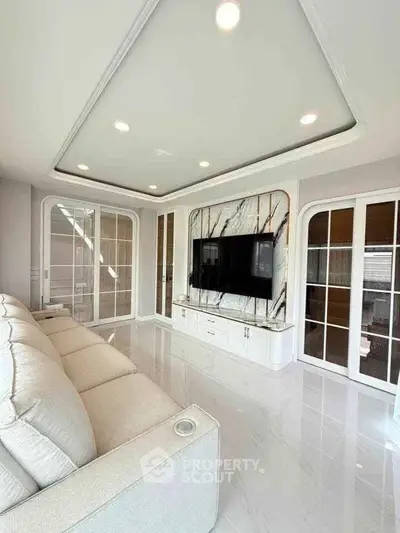 Luxurious modern living room with elegant marble TV wall and plush sofa