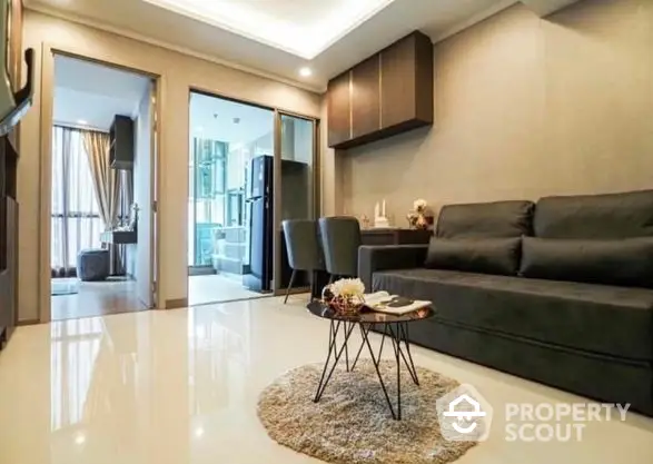 Elegant modern living room with glossy floor tiles, plush dark sofa, and stylish dining area leading to a cozy balcony, perfect for urban living.