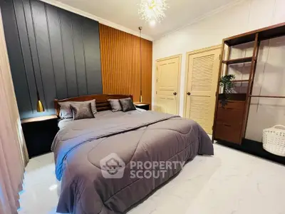 Luxurious bedroom with modern design and elegant lighting, featuring a cozy bed and stylish wooden accents.