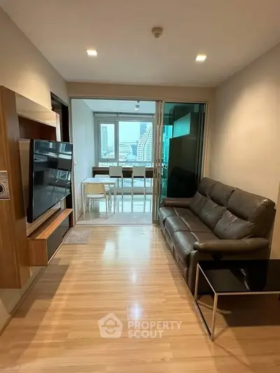 Modern living room with sleek furniture and city view, perfect for urban living.