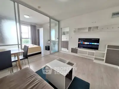 Modern open-plan living room with sleek furniture and natural light