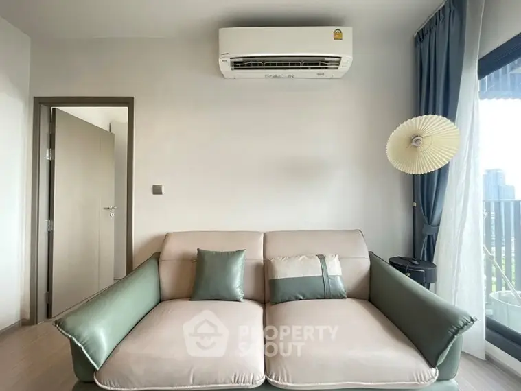 Modern living room with stylish sofa and air conditioning unit