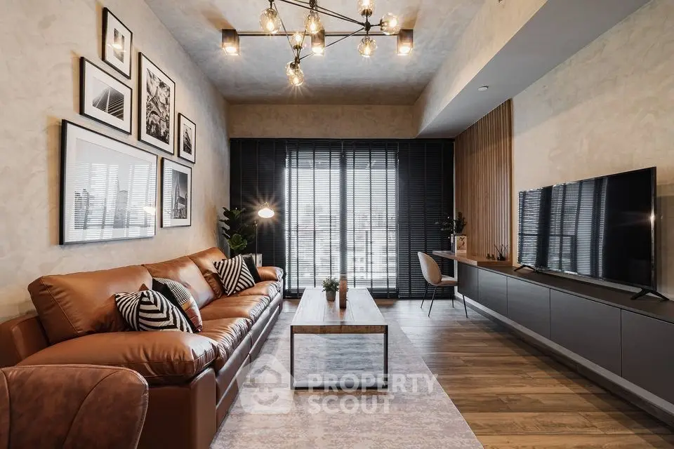 Modern living room with stylish decor, leather sofa, and large TV, perfect for relaxation and entertainment.