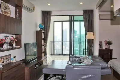 Modern living room with city view, featuring sleek furniture and stylish decor, perfect for urban living.