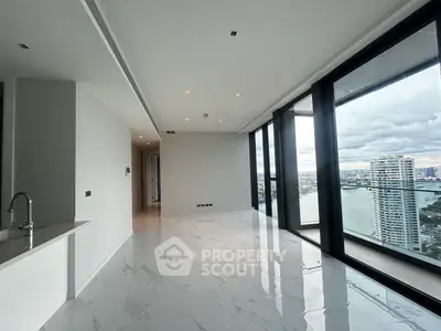 Luxurious corner unit with stunning river view and floor-to-ceiling windows in modern high-rise.