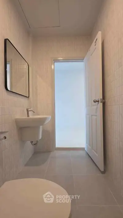 Modern minimalist bathroom with sleek fixtures and neutral tiles