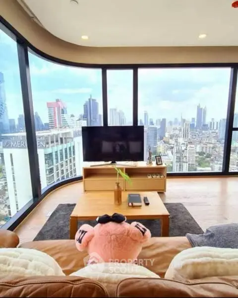 Stunning high-rise living room with panoramic city views and modern decor.