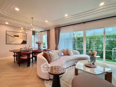 Luxurious living room with elegant decor and garden view, featuring modern furniture and ambient lighting.