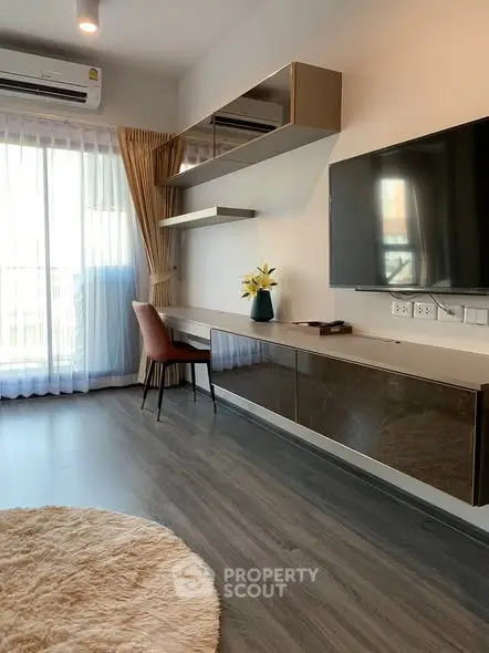 Modern living room with sleek furniture and large window for natural light.