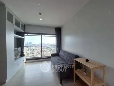 Modern living room with city view, featuring sleek furniture and large windows.